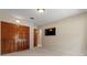 Bright bedroom featuring wood closet doors, carpet floors, and a wall-mounted television at 154 Golf Club Dr # 154, Longwood, FL 32779