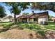 Charming home with mature landscaping, a well-maintained lawn, and an inviting exterior at 154 Golf Club Dr # 154, Longwood, FL 32779