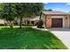 Charming single-story home featuring a well-manicured lawn, mature trees, and a brick-accented garage at 154 Golf Club Dr # 154, Longwood, FL 32779
