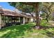 Charming home exterior with lush green lawn, mature trees, and well-maintained landscaping at 154 Golf Club Dr # 154, Longwood, FL 32779