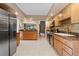 Large kitchen featuring stainless steel appliances, wood cabinets and tile floors at 154 Golf Club Dr # 154, Longwood, FL 32779