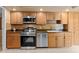 Bright kitchen with stainless steel appliances and tan cabinets at 154 Golf Club Dr # 154, Longwood, FL 32779