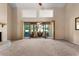 Bright living room with a fireplace, sliding glass doors to the patio, and neutral carpet at 154 Golf Club Dr # 154, Longwood, FL 32779