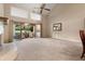 Bright living room with a fireplace, sliding glass doors to the patio, and neutral carpet at 154 Golf Club Dr # 154, Longwood, FL 32779