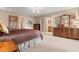 Charming main bedroom featuring a luxurious bed, a wooden dresser, and access to the en suite bathroom at 154 Golf Club Dr # 154, Longwood, FL 32779