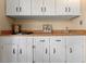 Wet bar with wooden countertops and white cabinets at 154 Golf Club Dr # 154, Longwood, FL 32779