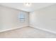 Carpeted bedroom has a window and neutral walls and trim at 16164 Point Rock Dr, Winter Garden, FL 34787
