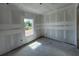 Bedroom under construction with a large window and smooth concrete floors at 1646 Cane Bamboo Drive, St Cloud, FL 34771