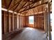 Unfinished bedroom featuring exposed ceiling beams and window with bright natural light at 1646 Cane Bamboo Drive, St Cloud, FL 34771