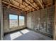 Unfinished bedroom featuring block walls, exposed ceiling beams, and bright natural light through window at 1646 Cane Bamboo Drive, St Cloud, FL 34771