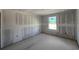 Bright bedroom with a window under construction and smooth concrete floors at 1646 Cane Bamboo Drive, St Cloud, FL 34771