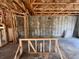 Unfinished interior view featuring concrete block walls, wood framing, and a concrete floor at 1646 Cane Bamboo Drive, St Cloud, FL 34771