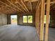 Unfinished interior showing a concrete floor, block walls, and framed windows and door at 1646 Cane Bamboo Drive, St Cloud, FL 34771