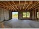 Unfinished room view with concrete flooring, block wall, and exterior view, showing wood framing at 1646 Cane Bamboo Drive, St Cloud, FL 34771