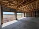 Spacious unfinished garage with a concrete floor, exposed ceiling beams, and a view of the surrounding landscape at 1646 Cane Bamboo Drive, St Cloud, FL 34771