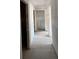Under-construction hallway with visible framework and bare concrete floors, awaiting its final finishes at 1646 Cane Bamboo Drive, St Cloud, FL 34771