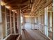 A look into an unfinished home's interior, highlighting the stud framing and spacious layout for potential buyers at 1646 Cane Bamboo Drive, St Cloud, FL 34771