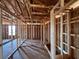 Exposed beams and framework create a modern interior, revealing the open-concept layout of the unfinished property at 1646 Cane Bamboo Drive, St Cloud, FL 34771
