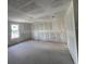 Open-concept living room with unfinished ceilings and a view from the window at 1646 Cane Bamboo Drive, St Cloud, FL 34771