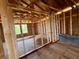 Unfinished living room featuring exposed ceiling beams and window with bright natural light at 1646 Cane Bamboo Drive, St Cloud, FL 34771