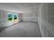 Bright living room with two windows under construction and smooth concrete floors at 1646 Cane Bamboo Drive, St Cloud, FL 34771