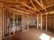 Unfinished living room showcasing its spacious layout, exposed ceiling beams, and natural light at 1646 Cane Bamboo Drive, St Cloud, FL 34771