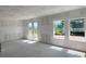Bright, unfinished living area with large glass doors and windows, providing ample natural light and outdoor access at 1646 Cane Bamboo Drive, St Cloud, FL 34771