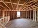 Unfinished living room featuring exposed ceiling beams and window with bright natural light at 1646 Cane Bamboo Drive, St Cloud, FL 34771