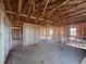 Unfinished living room showcasing its spacious layout, exposed ceiling beams, and natural light at 1646 Cane Bamboo Drive, St Cloud, FL 34771