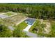 Aerial view showcasing a single-Gathering home on a well-manicured lawn, surrounded by lush trees at 17301 Sw 41St Cir, Ocala, FL 34473