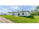 Rear exterior view of the house showing sliding door and green grass at 17301 Sw 41St Cir, Ocala, FL 34473