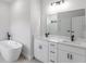 Luxurious bathroom with double vanity, a soaking tub, and modern black fixtures at 17301 Sw 41St Cir, Ocala, FL 34473