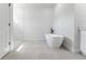 Bright bathroom featuring modern soaking tub and glass shower door at 17301 Sw 41St Cir, Ocala, FL 34473