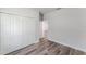Bedroom boasts wood-look floors, closet with bi-fold doors, and neutral paint at 17301 Sw 41St Cir, Ocala, FL 34473