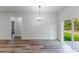 Dining room showcasing sliding glass doors to backyard and stylish lighting at 17301 Sw 41St Cir, Ocala, FL 34473