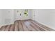 Bright entryway with white walls, modern wood flooring, and a welcoming white door at 17301 Sw 41St Cir, Ocala, FL 34473