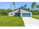 Charming single-story home featuring a modern design, manicured lawn, and a spacious two-car garage at 17301 Sw 41St Cir, Ocala, FL 34473