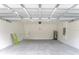 Open garage featuring block walls, concrete flooring and modern water heater at 17301 Sw 41St Cir, Ocala, FL 34473