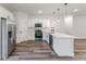 Modern kitchen with stainless appliances, white cabinetry, and an island with pendant lighting at 17301 Sw 41St Cir, Ocala, FL 34473