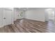 Spacious living area featuring gray wood floors, white walls, and plenty of natural light at 17301 Sw 41St Cir, Ocala, FL 34473