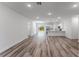 Bright and spacious living area with modern wood flooring seamlessly connecting to the open-concept kitchen at 17301 Sw 41St Cir, Ocala, FL 34473