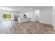 Bright, open living space flows into a modern kitchen, complete with stainless appliances and wood flooring at 17301 Sw 41St Cir, Ocala, FL 34473