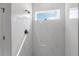 Modern shower with large-format marble-look tiles and a built-in window for natural light at 17301 Sw 41St Cir, Ocala, FL 34473