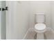 Powder room featuring a standard toilet with a white finish and neutral tile flooring at 17301 Sw 41St Cir, Ocala, FL 34473