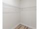 Walk-in closet features wire shelving and laminate wood flooring at 17301 Sw 41St Cir, Ocala, FL 34473