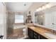 Bathroom with granite countertops, double sinks, walk-in shower, and separate tub at 182 Westmoreland Cir, Kissimmee, FL 34744
