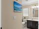 Clean bathroom with dark cabinets, white tile floors, and a framed mirror at 182 Westmoreland Cir, Kissimmee, FL 34744