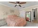 Cozy bedroom features neutral walls, a ceiling fan, and a closet with a full-length mirror at 182 Westmoreland Cir, Kissimmee, FL 34744