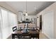 Dining area with modern table setting, pendant lighting and a view to the kitchen at 182 Westmoreland Cir, Kissimmee, FL 34744