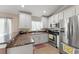 Bright kitchen featuring white cabinets, stainless steel appliances, and granite countertops at 182 Westmoreland Cir, Kissimmee, FL 34744